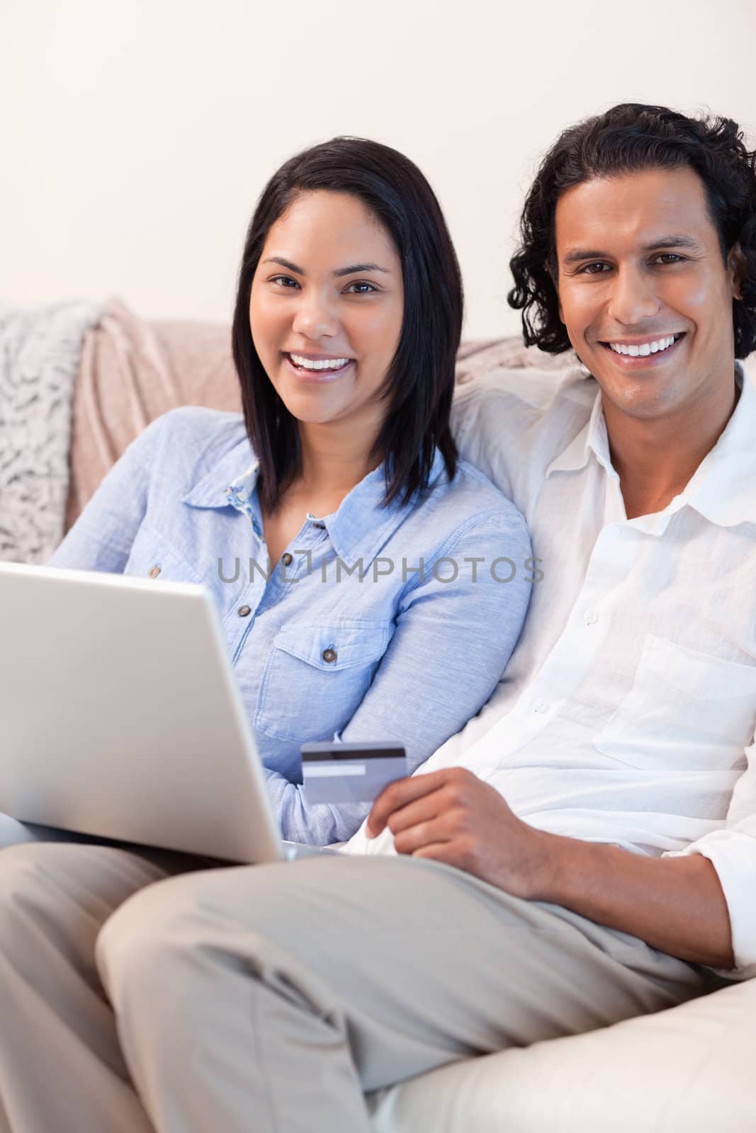 Young couple with notebook on the couch