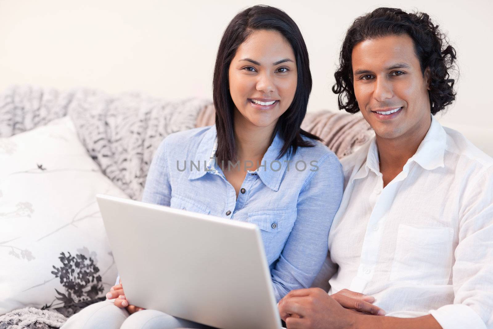Young couple with laptop on the sofa
