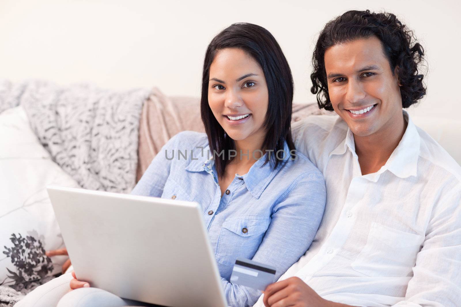 Young couple with notebook on the sofa