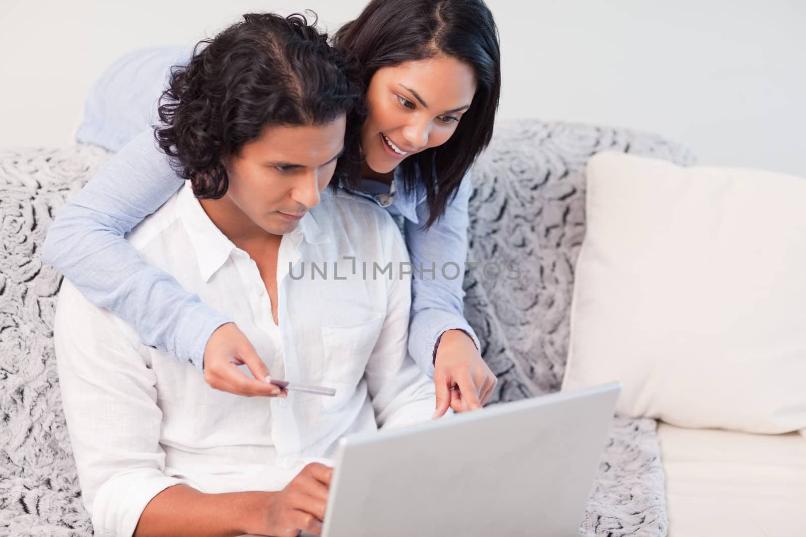 Young couple booking vacations online