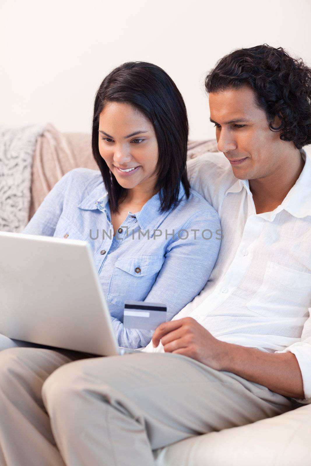 Young couple booking holidays online together