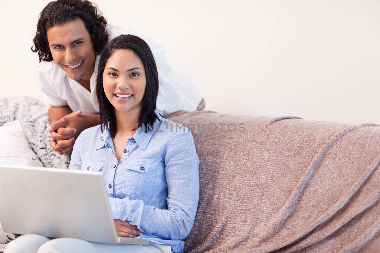 Young couple on the sofa surfing on the internet