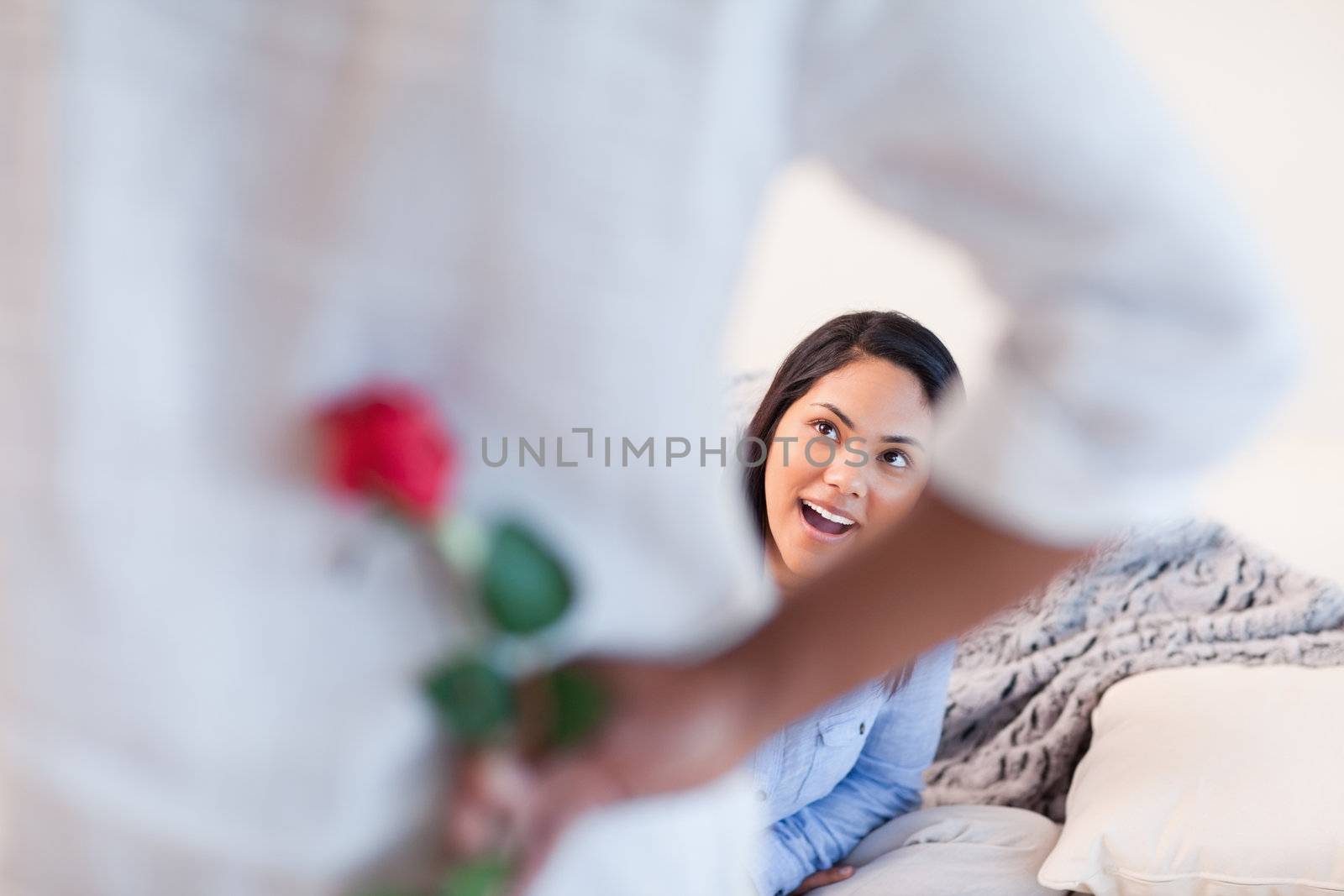 Young woman about to get a rose from her boyfriend