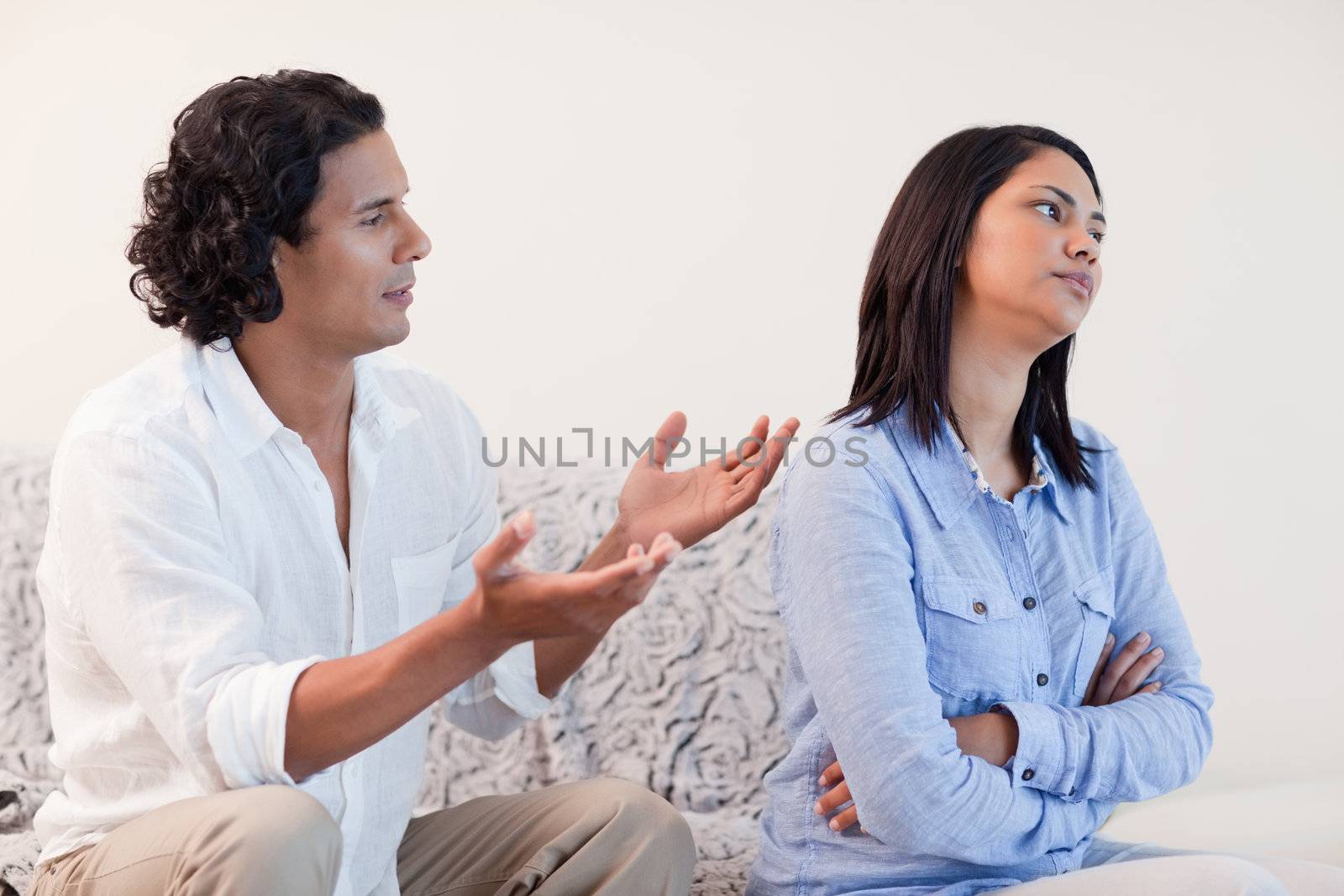 Young man begging his girlfriend for pardon