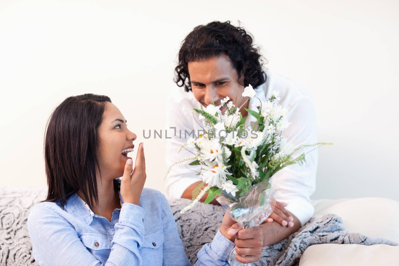 Young man giving his girlfriend a bouquet