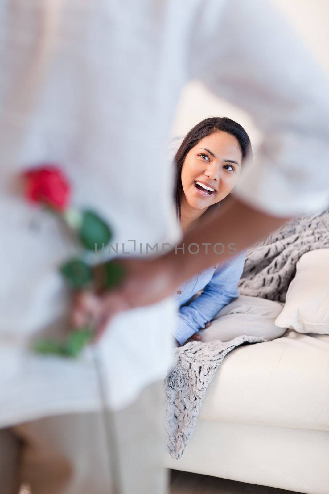 Young woman about to get a flower by her boyfriend