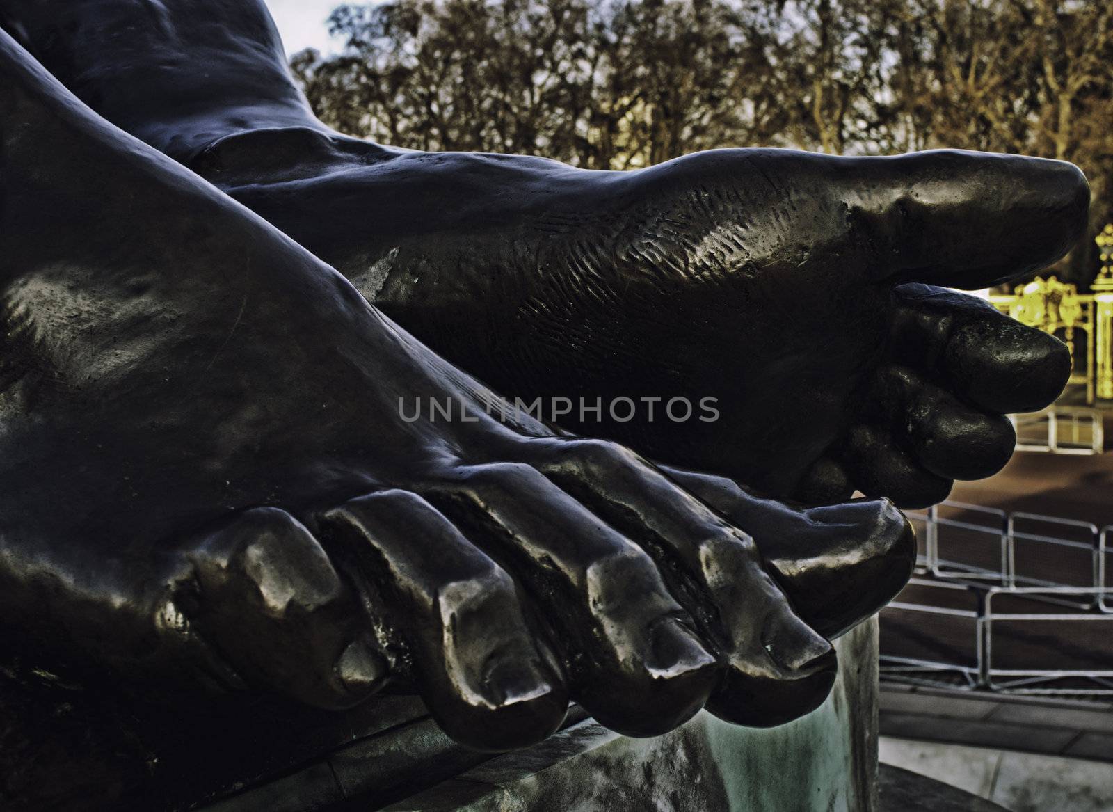 Statue detail of bare feet painted black with realistic morpholgy and anatomical detail of toes and toenails