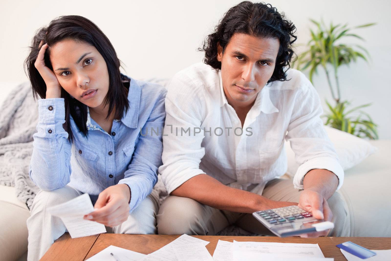 Young couple calculating their costs