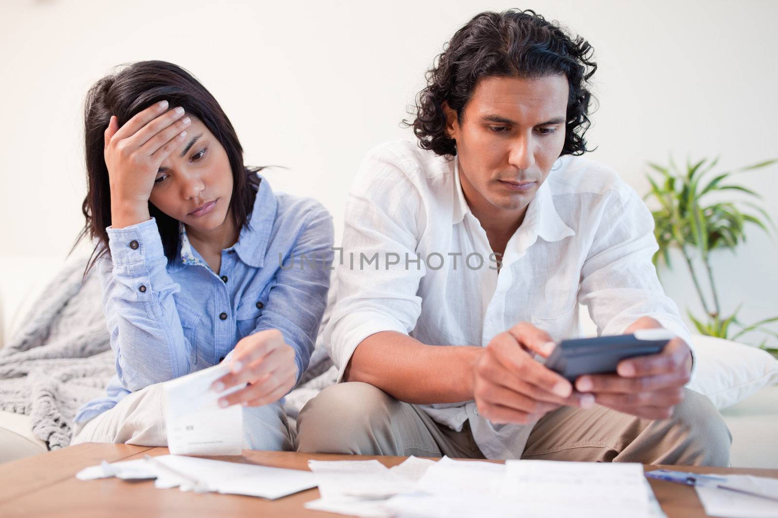 Young couple checking bills