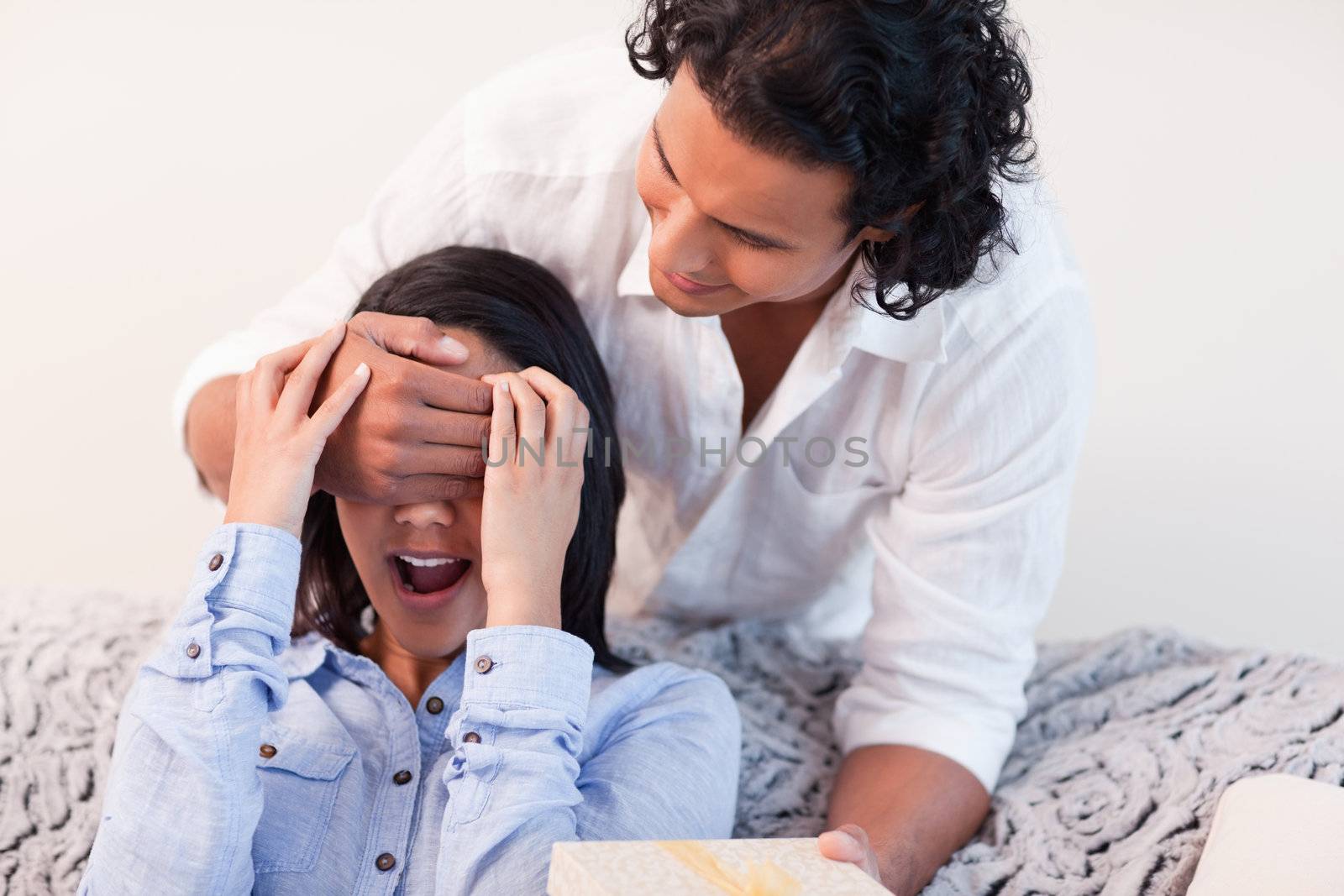 Young man giving his girlfriend a small present