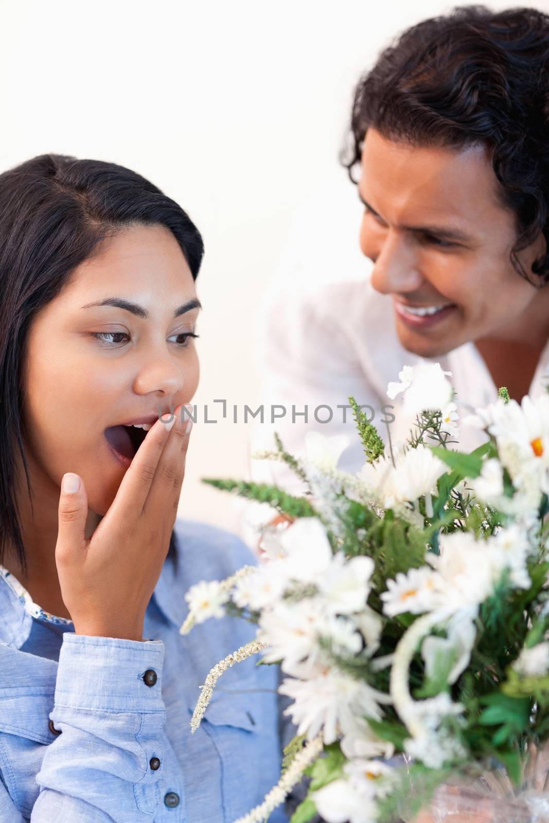 Young woman surprised by the bouquet she got from her boyfriend
