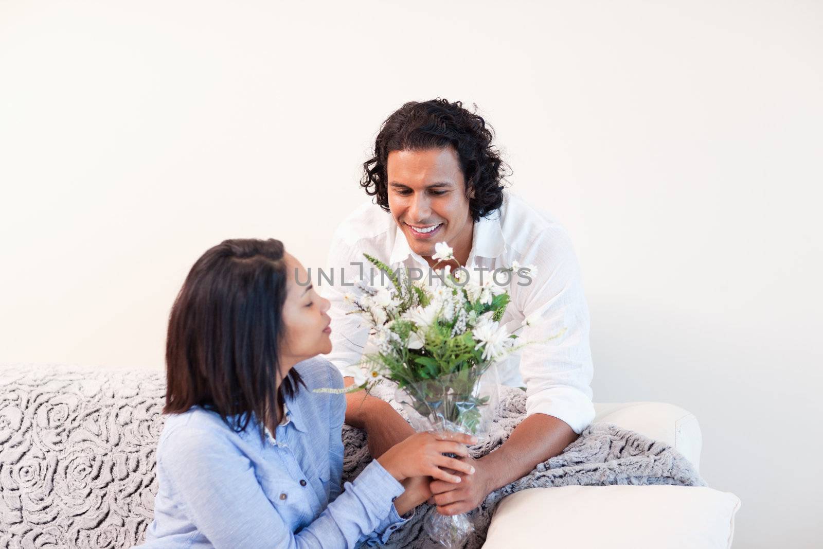 Young man giving his girlfriend flowers