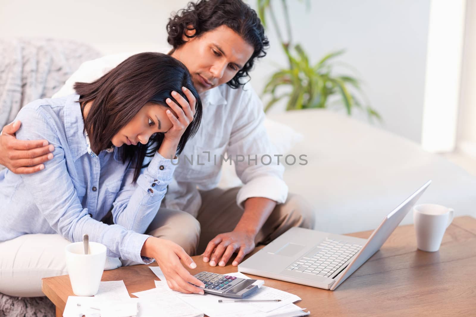 Side view of young couple having a hard time paying their bills