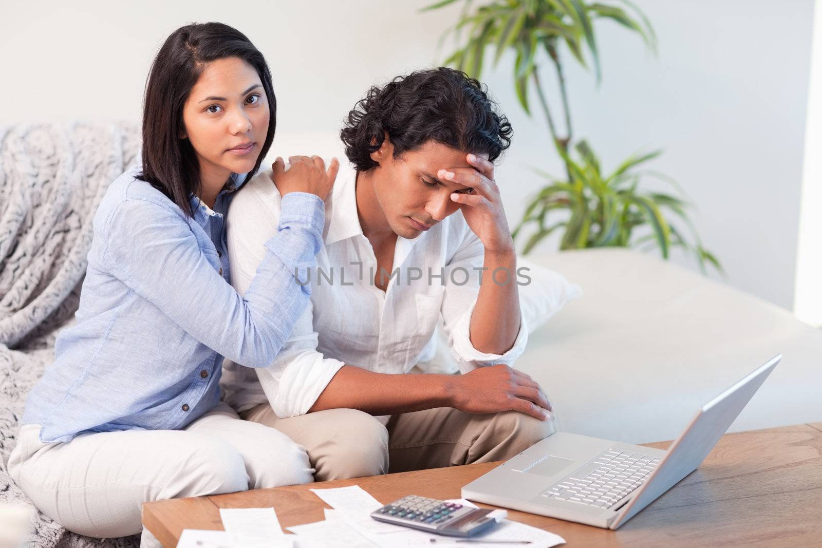 Young couple on the sofa doing their calculations