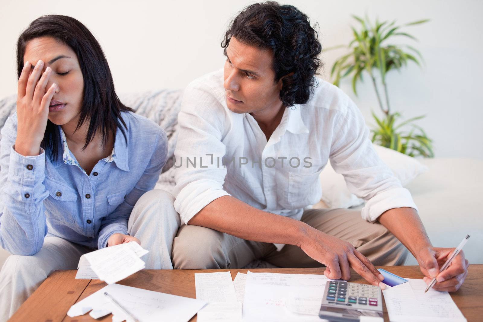 Young couple checking their bills