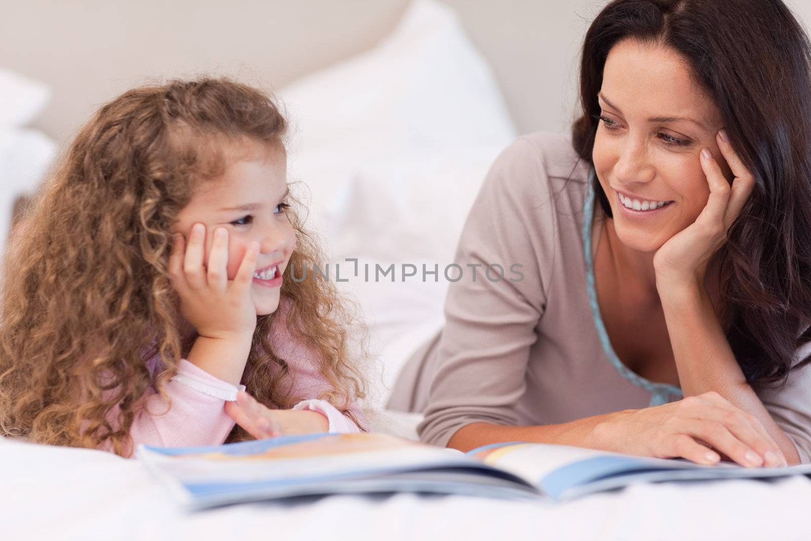 Young mother reading a bedtime story for her daughter