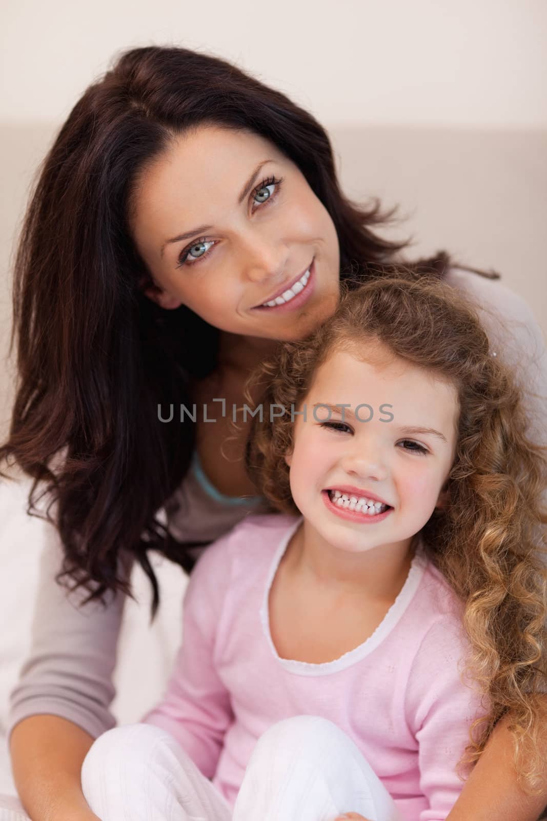 Young mother embracing her daughter