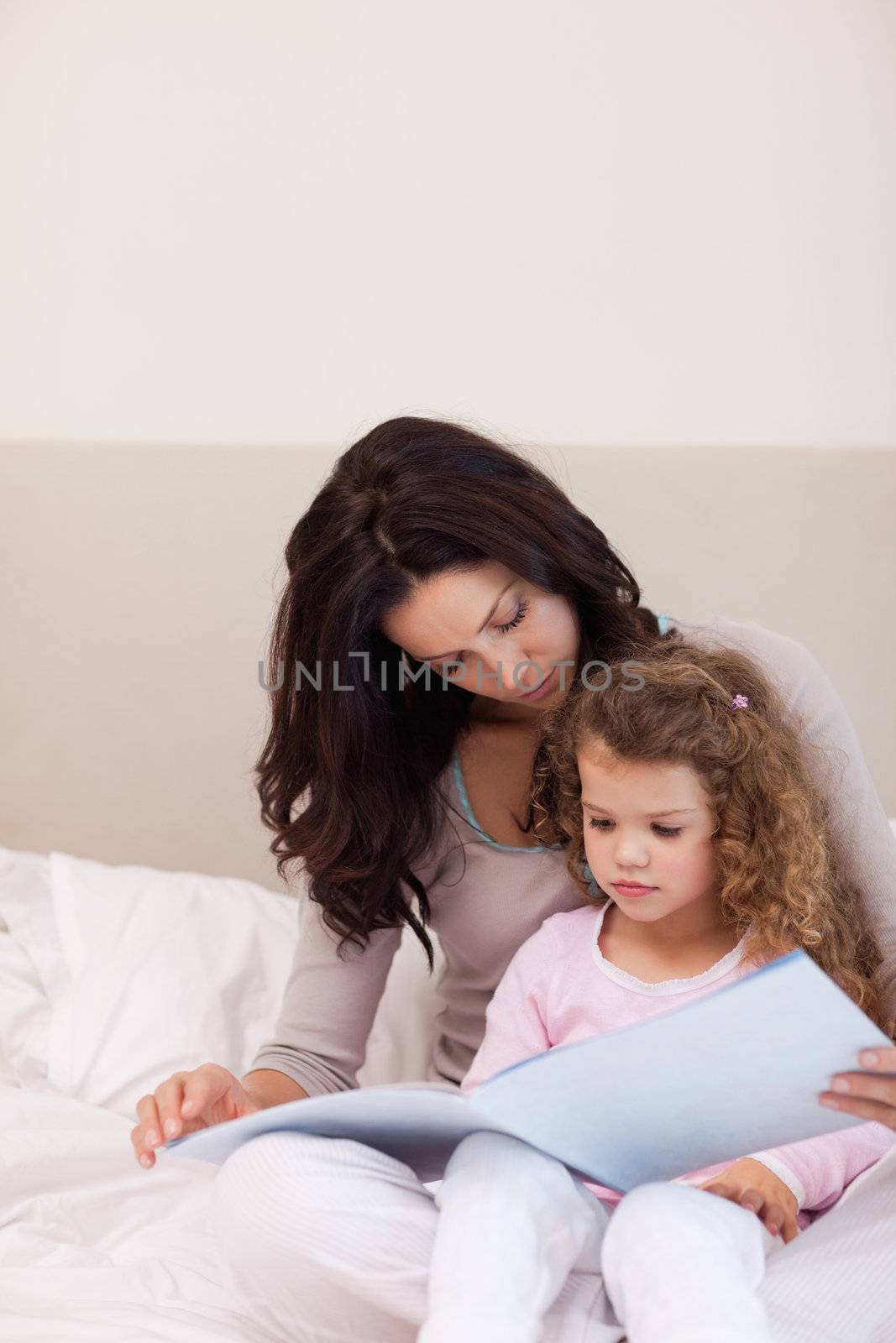 Young mother reading a story for her daughter