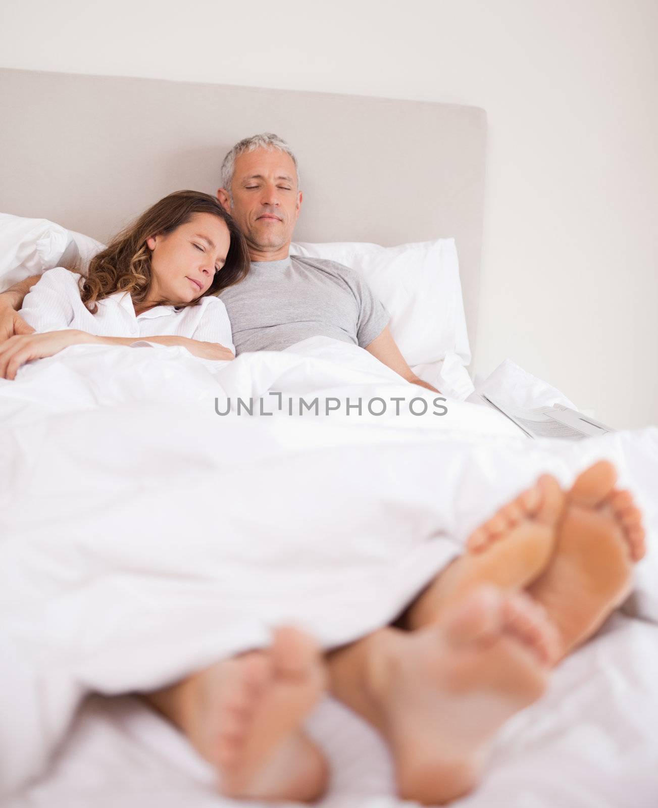 Portrait of a lovely couple sleeping in their bedroom
