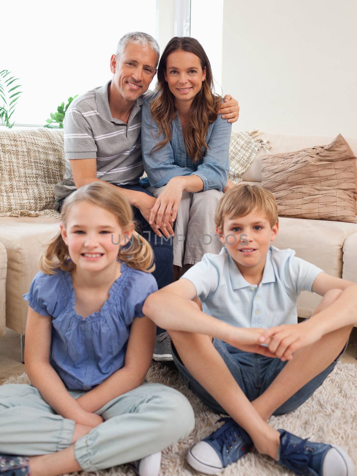 Portrait of a family posing in a living room