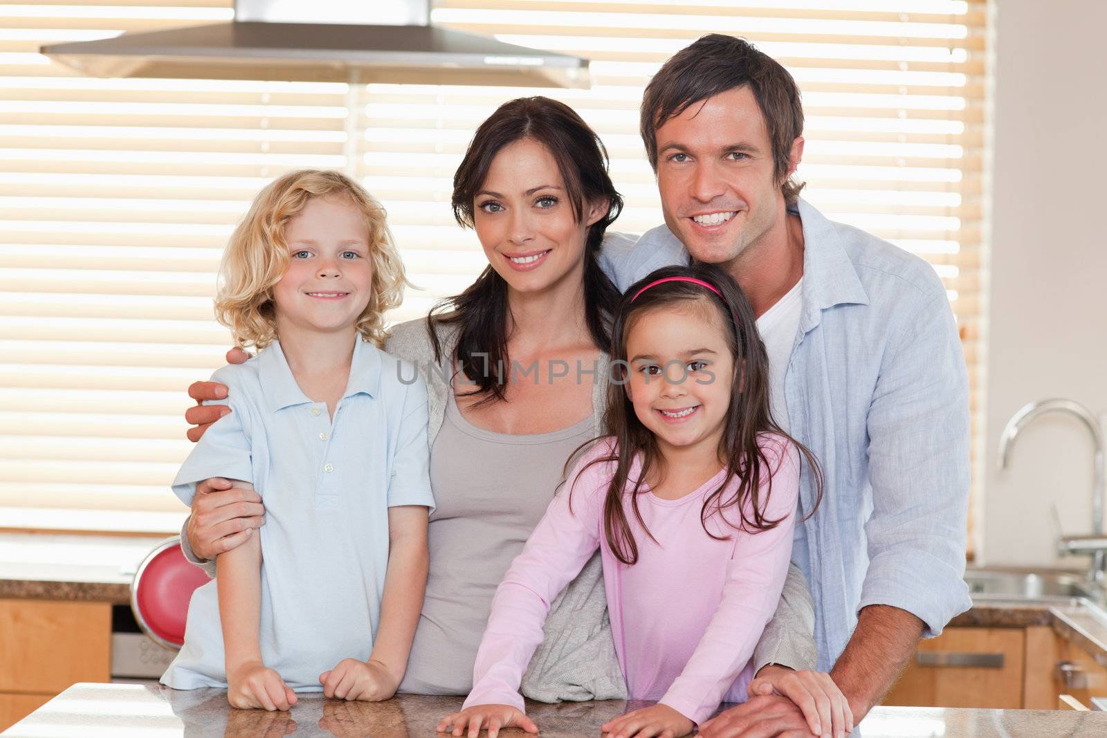Family standing up in a kitchen