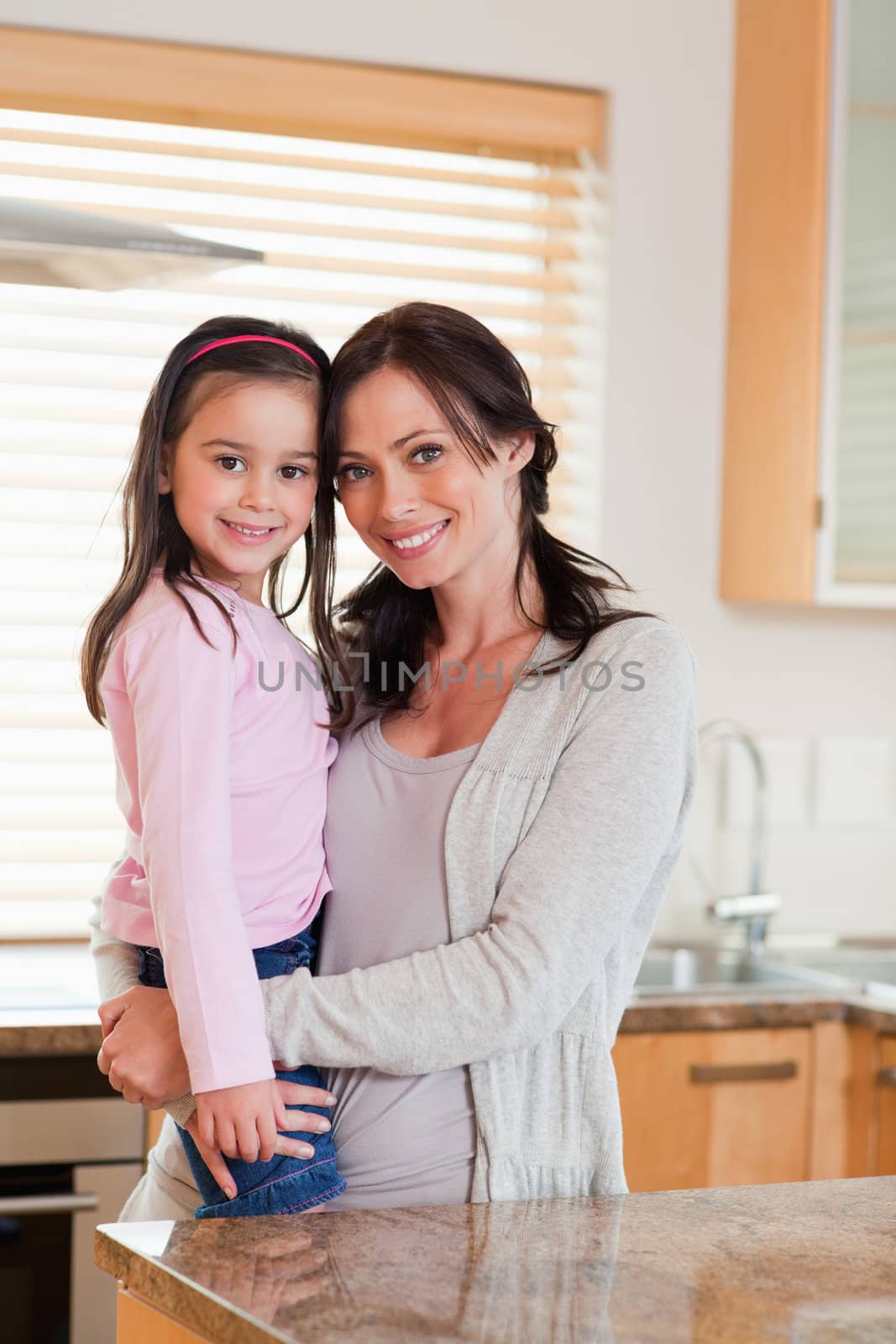 Portrait of a girl and her mother in a kitchen