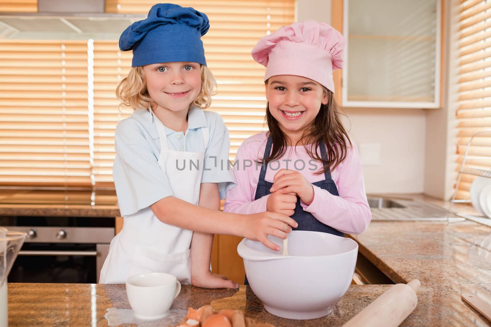 Siblings baking together in a kitchen