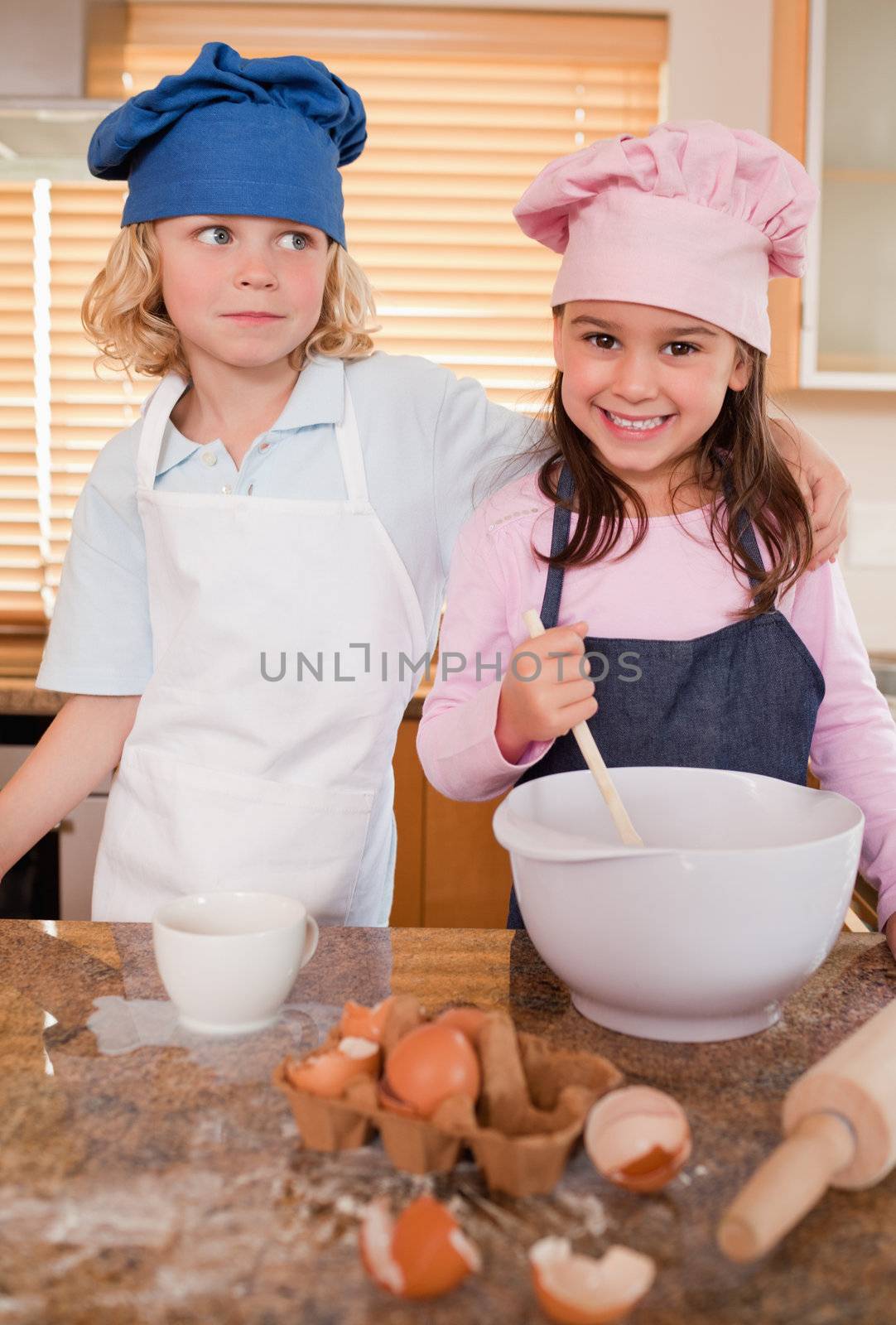Portrait of siblings baking together in a kitchen