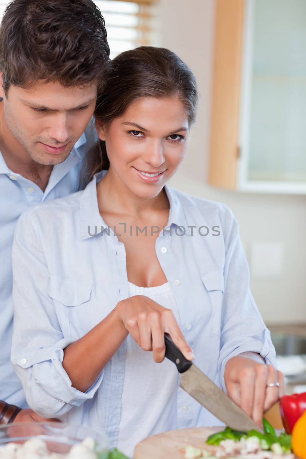 Portrait of a young couple cooking in their kitchen