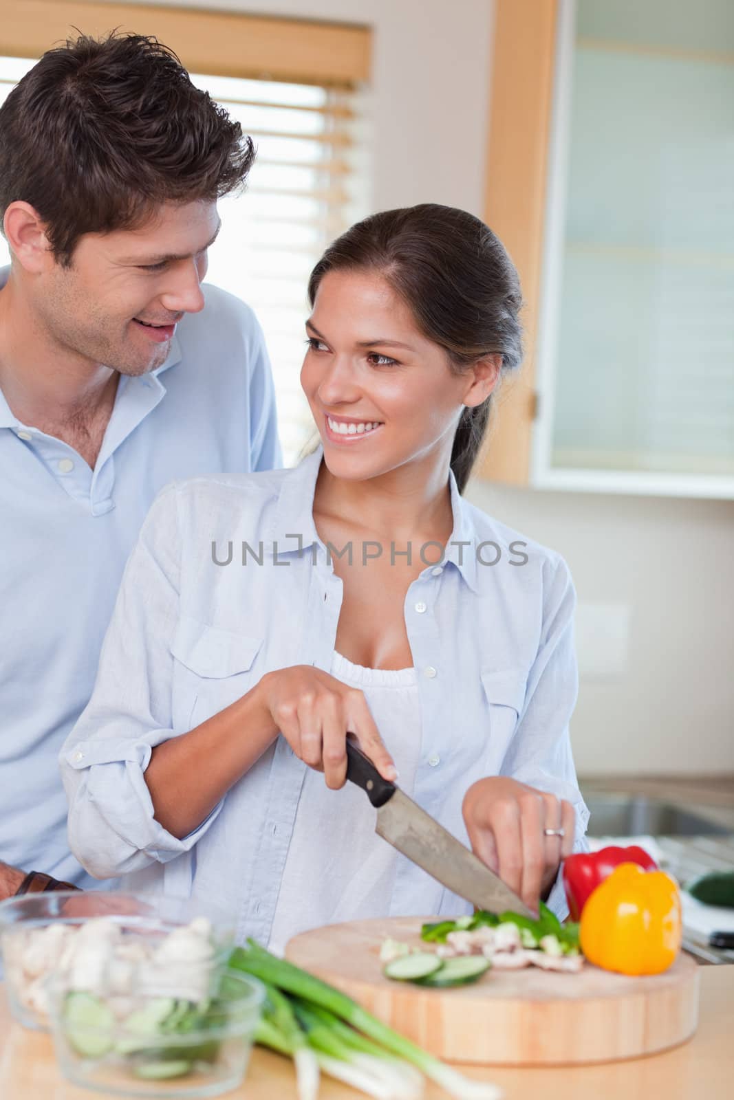 Portrait of a happy couple cooking in their kitchen