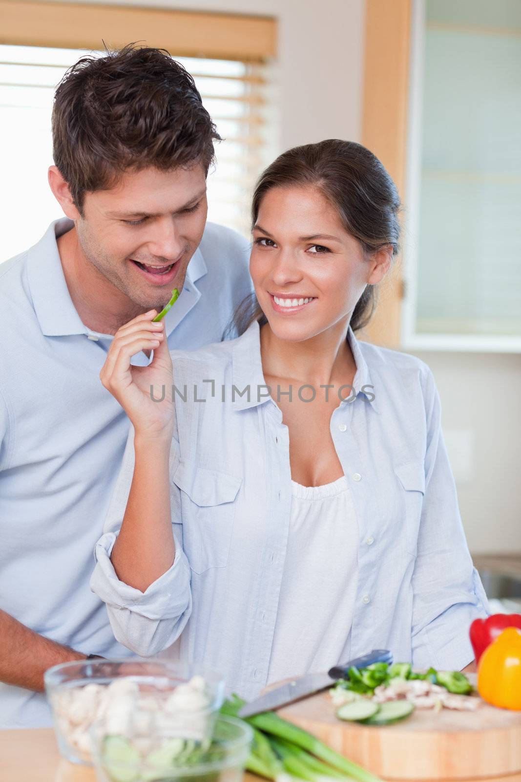Portrait of a beautiful couple cooking in their kitchen