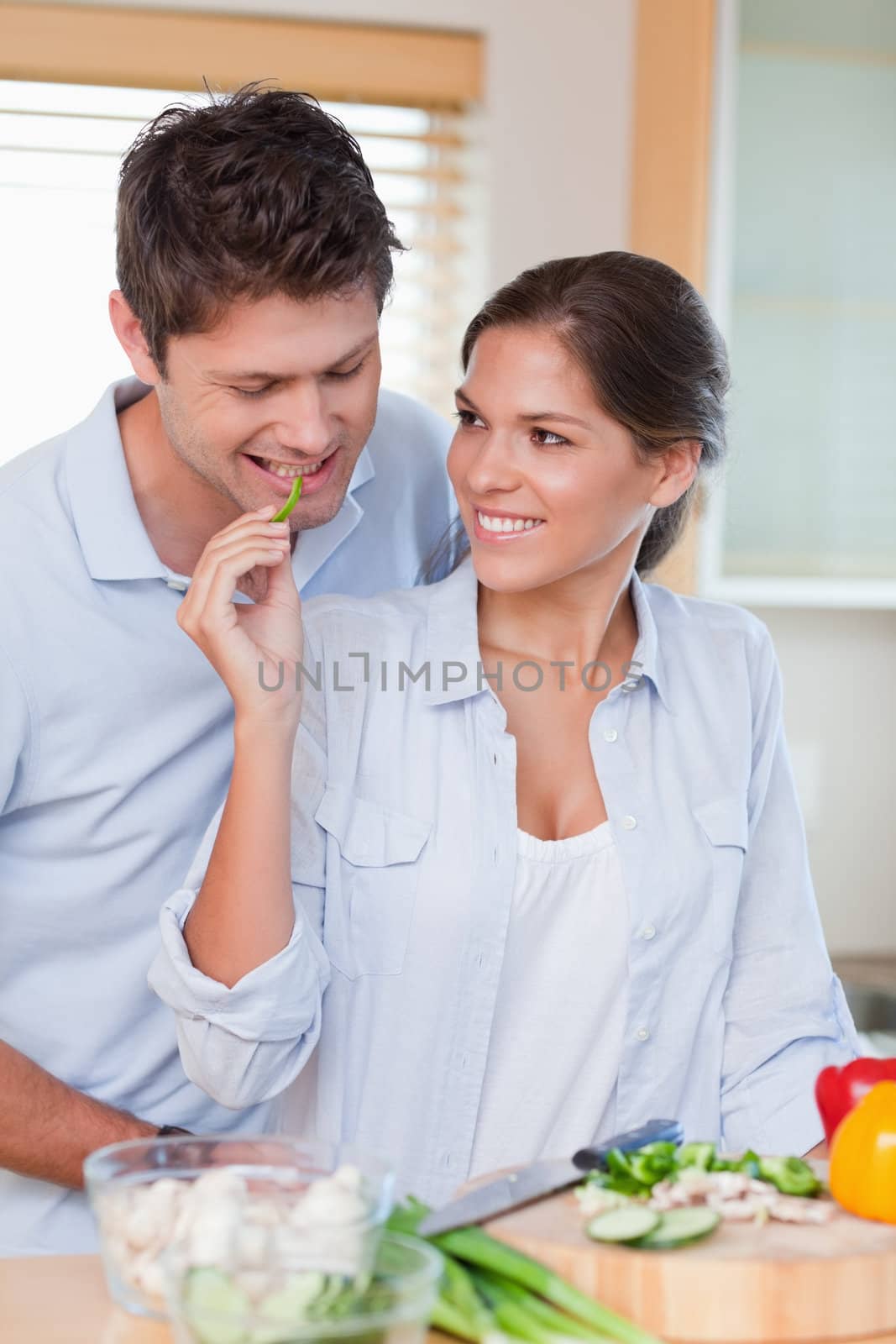 Portrait of a smiling couple cooking in their kitchen