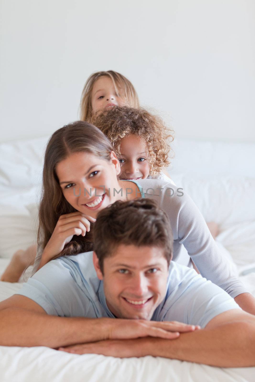 Portrait of a family lying on each other by Wavebreakmedia