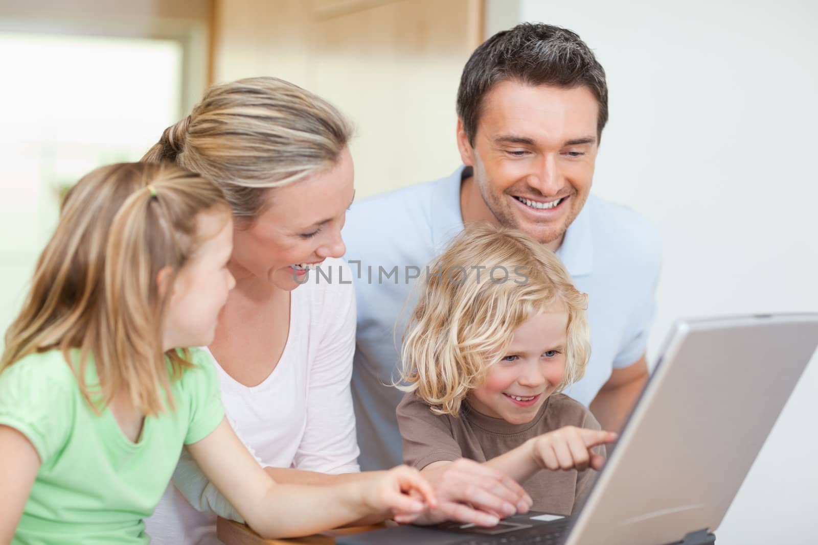 Family using notebook in the kitchen by Wavebreakmedia