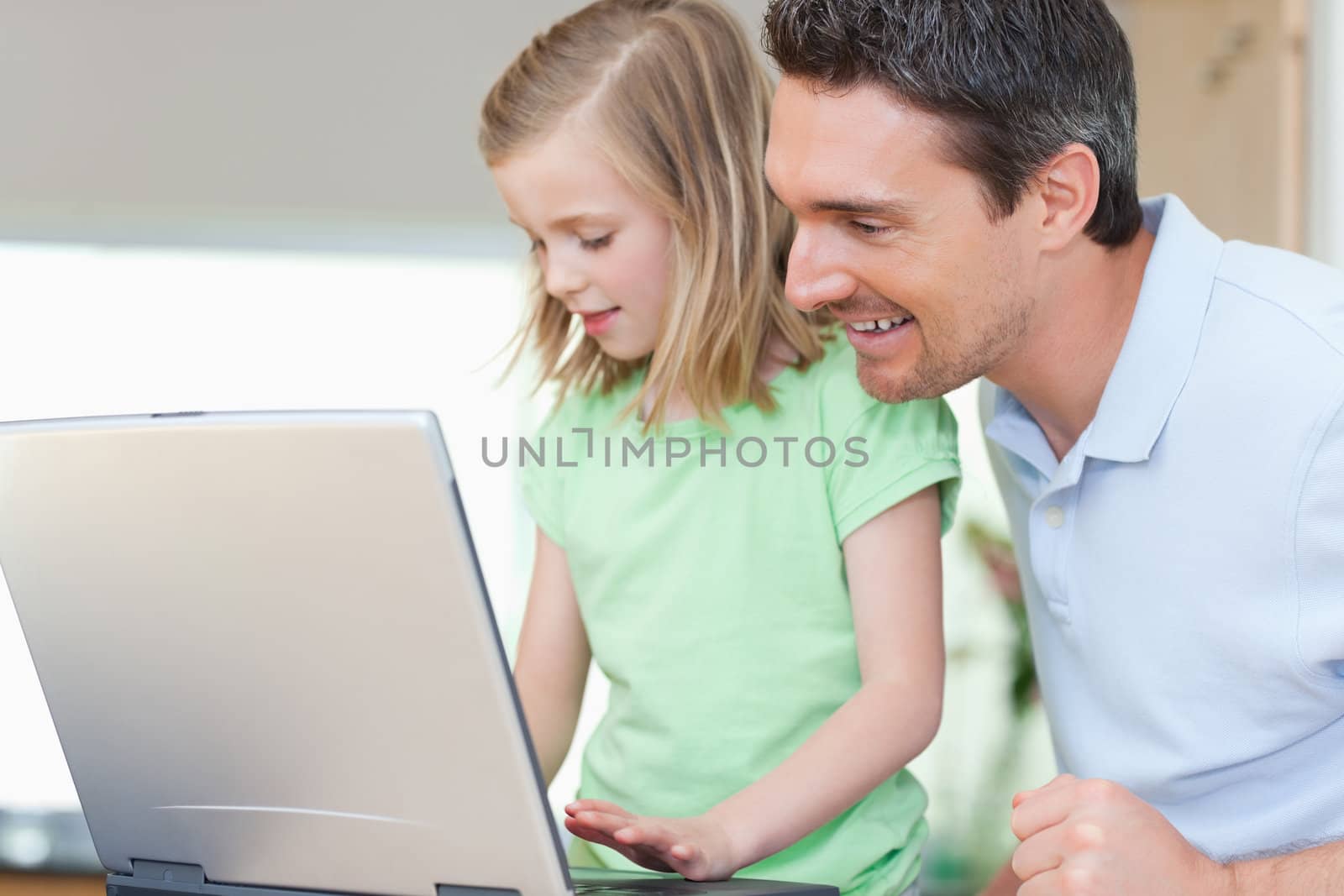 Father and daughter together with notebook