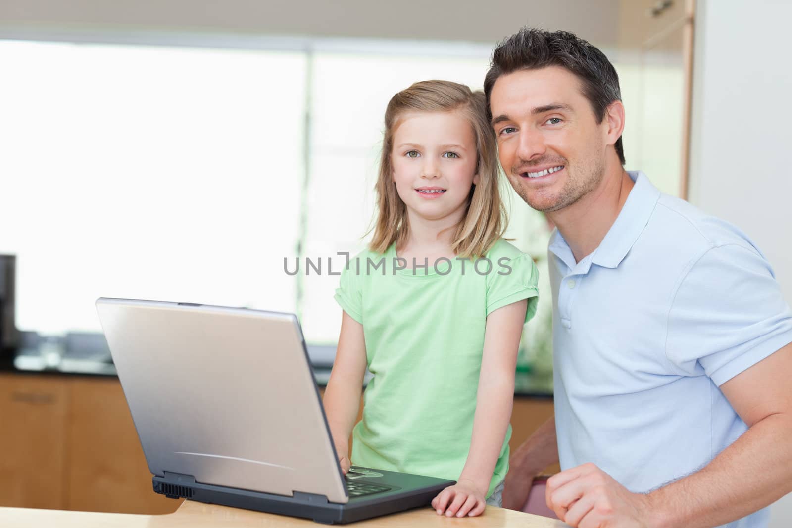 Father and daughter using laptop together