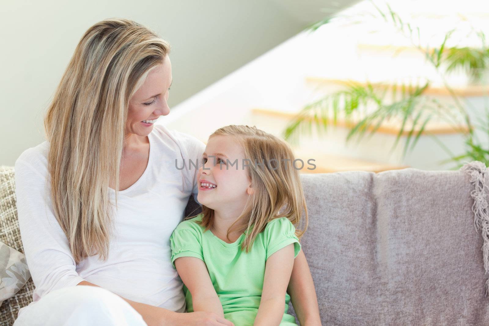 Mother and daughter sitting on the sofa