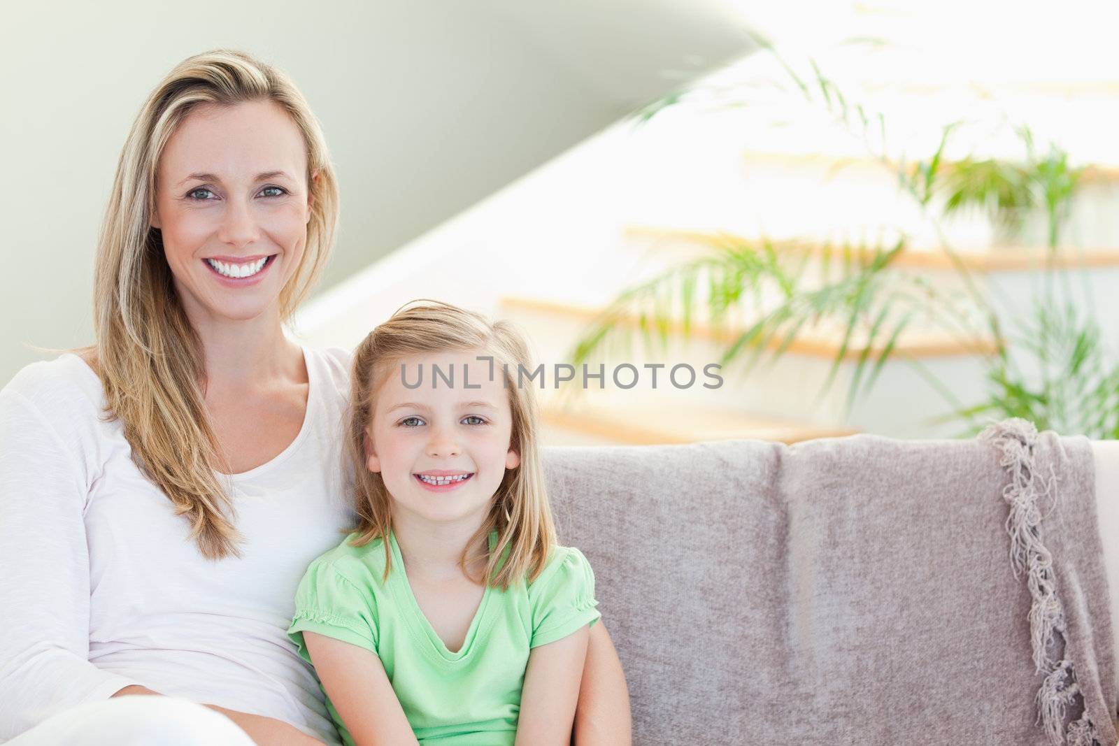 Mother and daughter sitting on the couch together