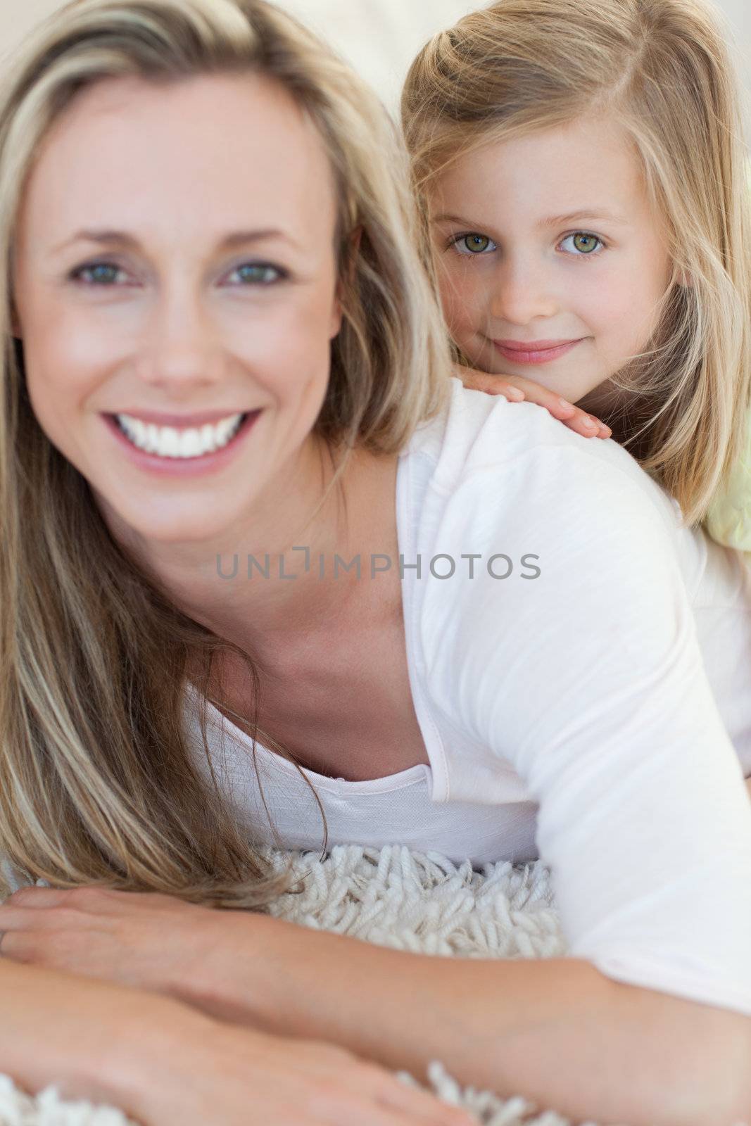 Happy mother and daughter together on the floor