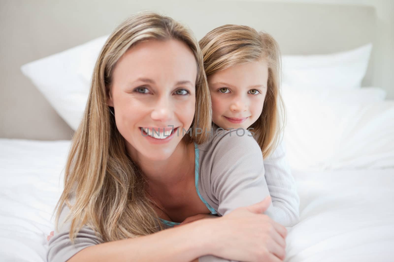 Little girl lying on her mothers back