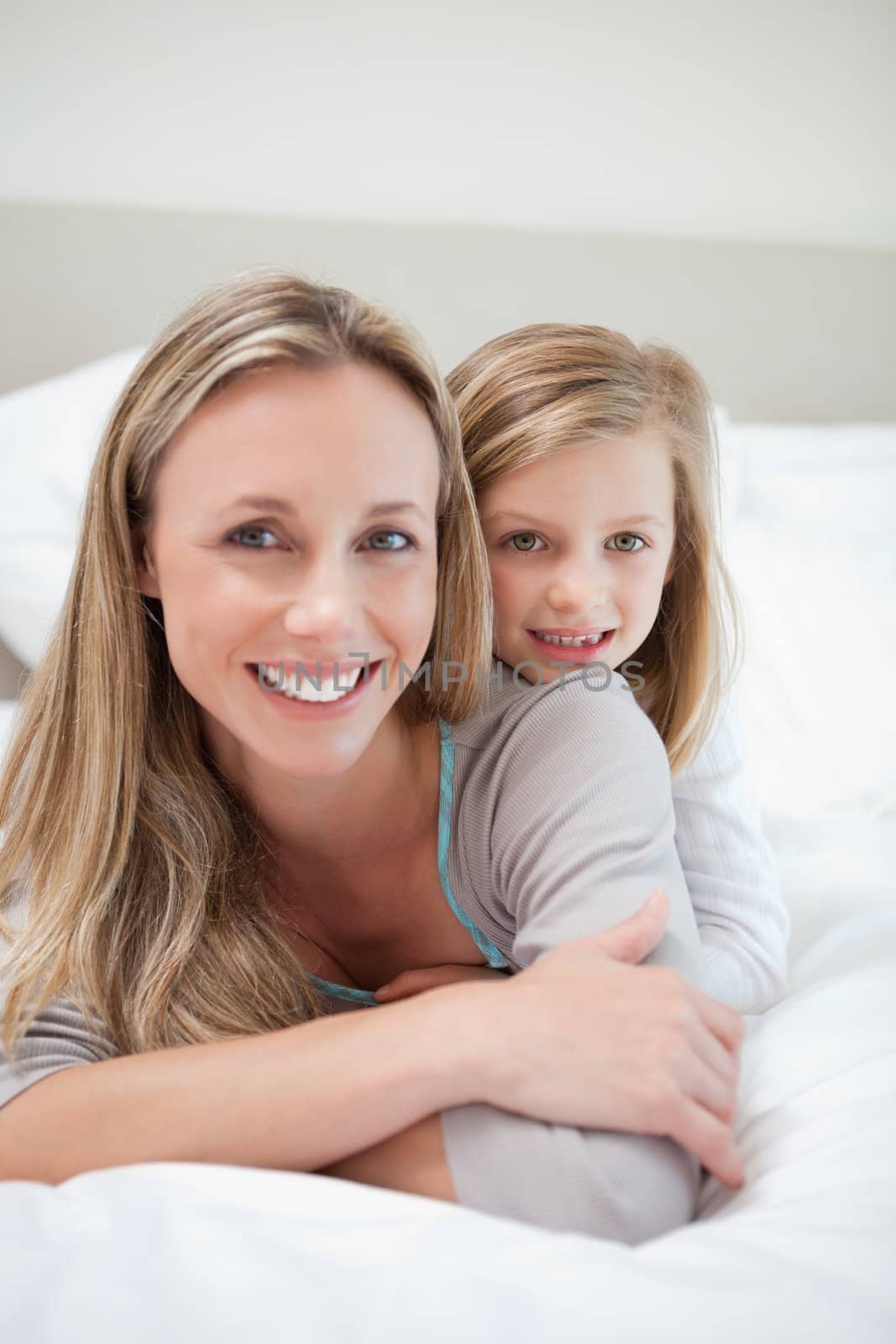 Little girl laying on her mothers back