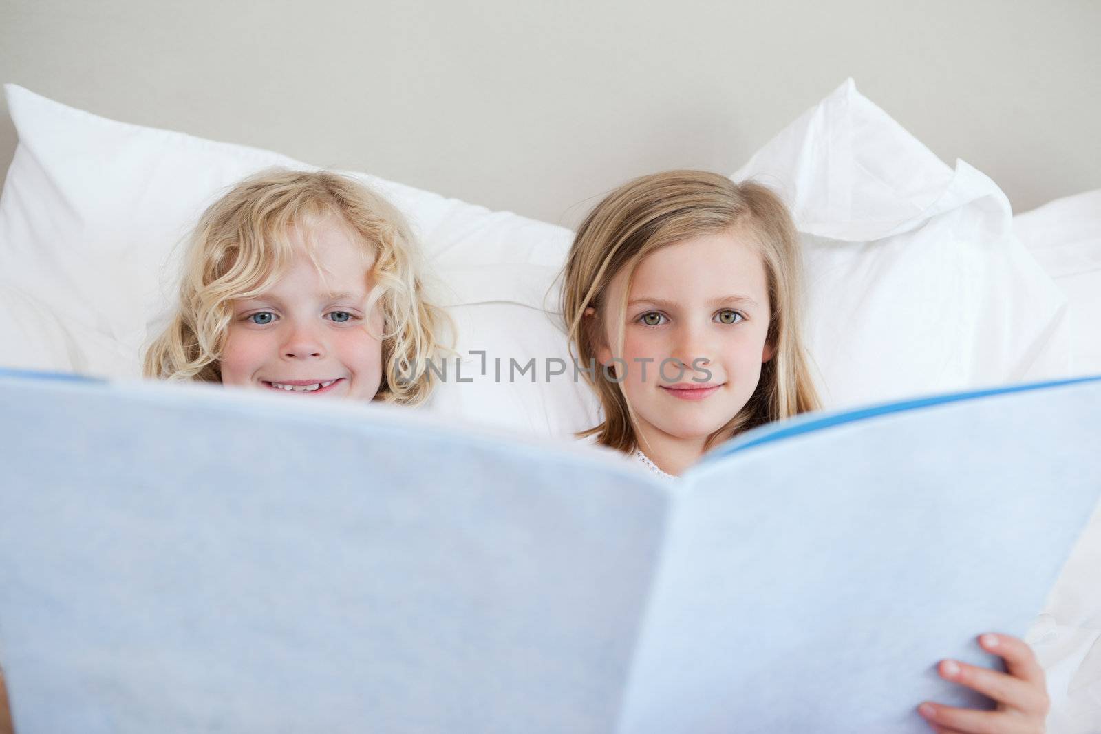 Brother and sister reading bedtime story together