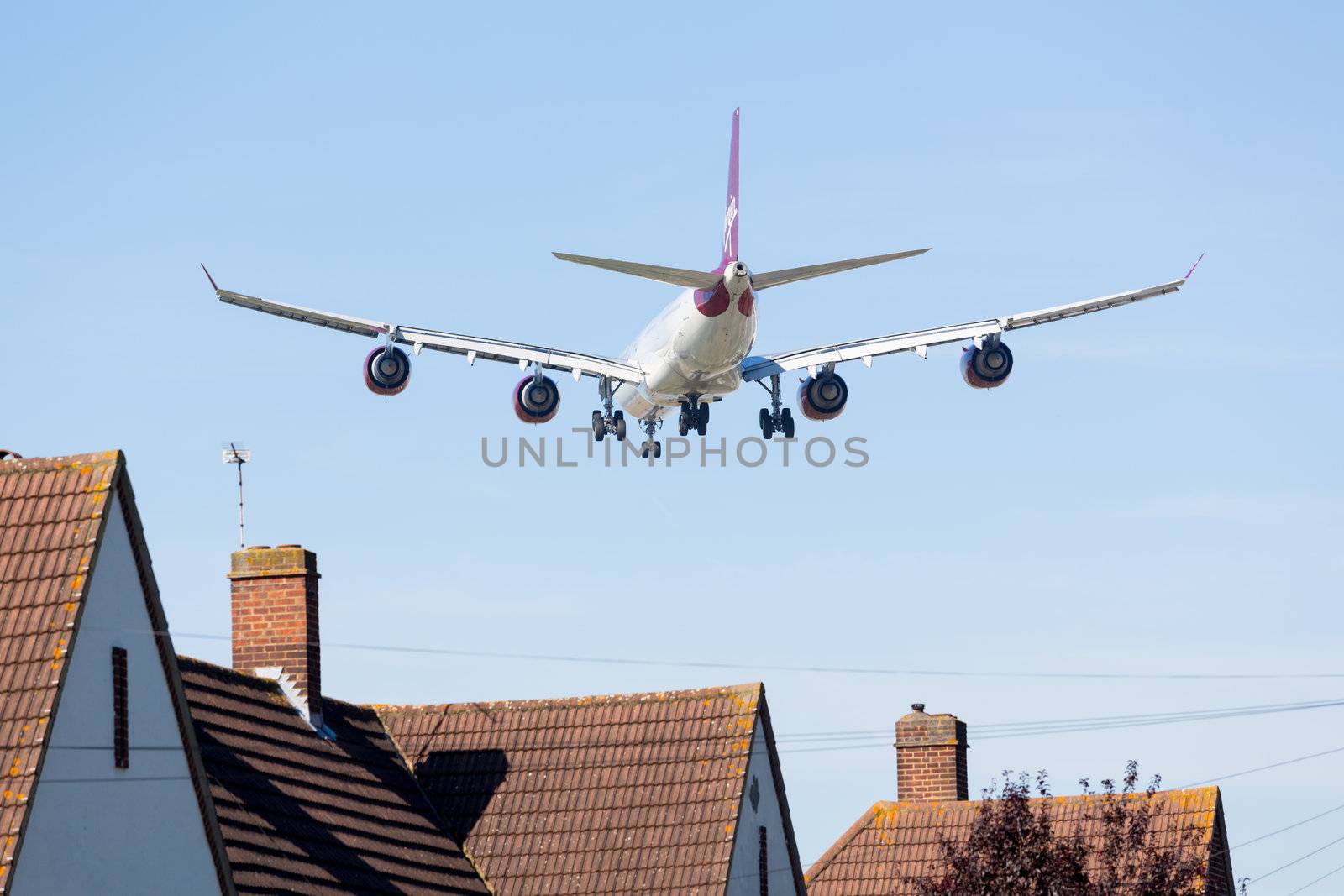 HEATHROW AIRPORT, LONDON - 9 SEPTEMBER: VIrgin Atlantic A340 approaches Heathrow on 9 September 2012. London Heathrow is the third busiest airport in the world.