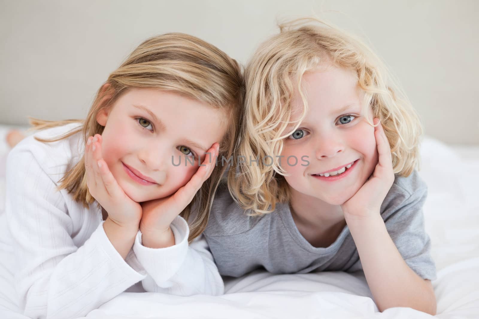 Brother and sister lying on the bed together
