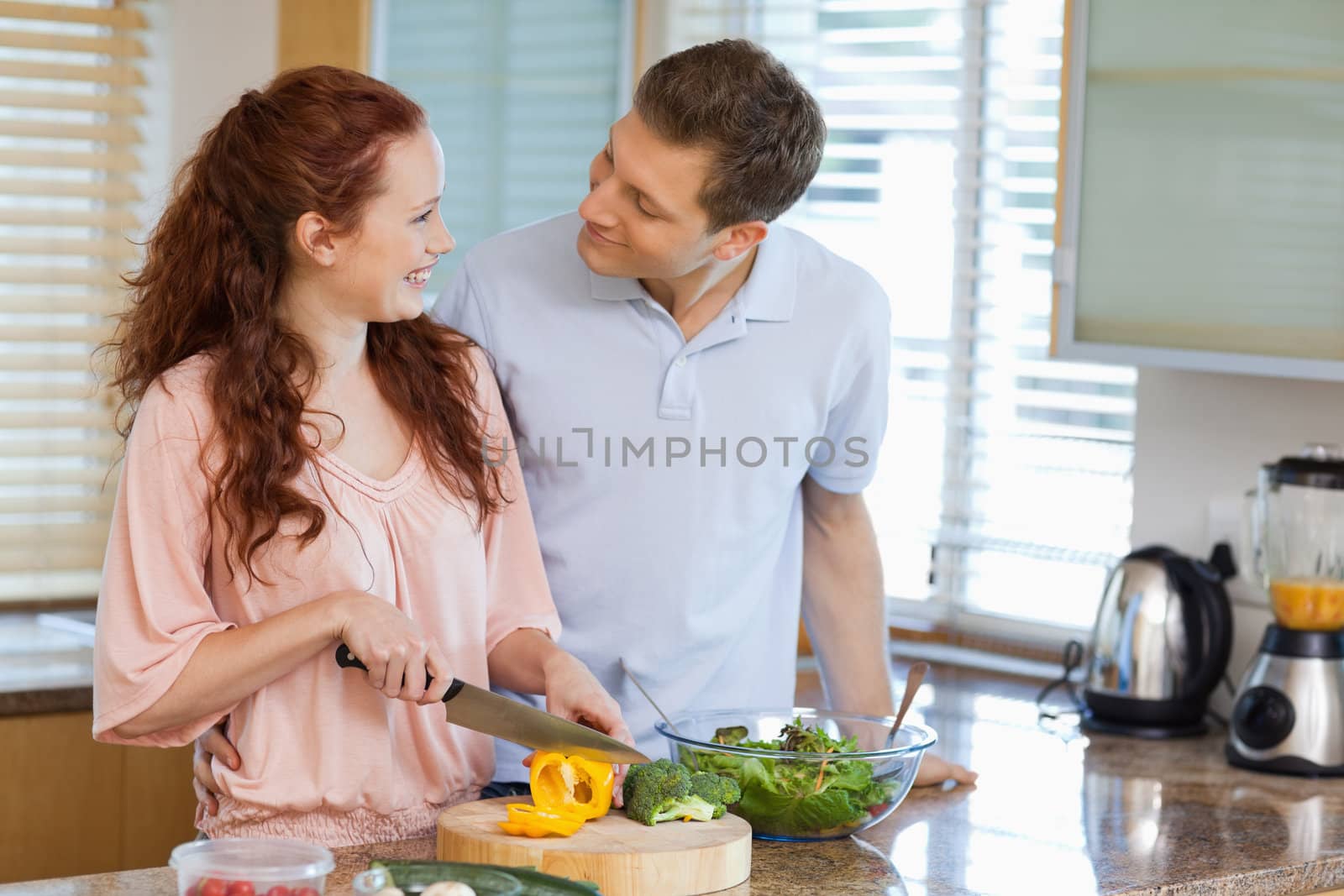 Couple preparing salad together