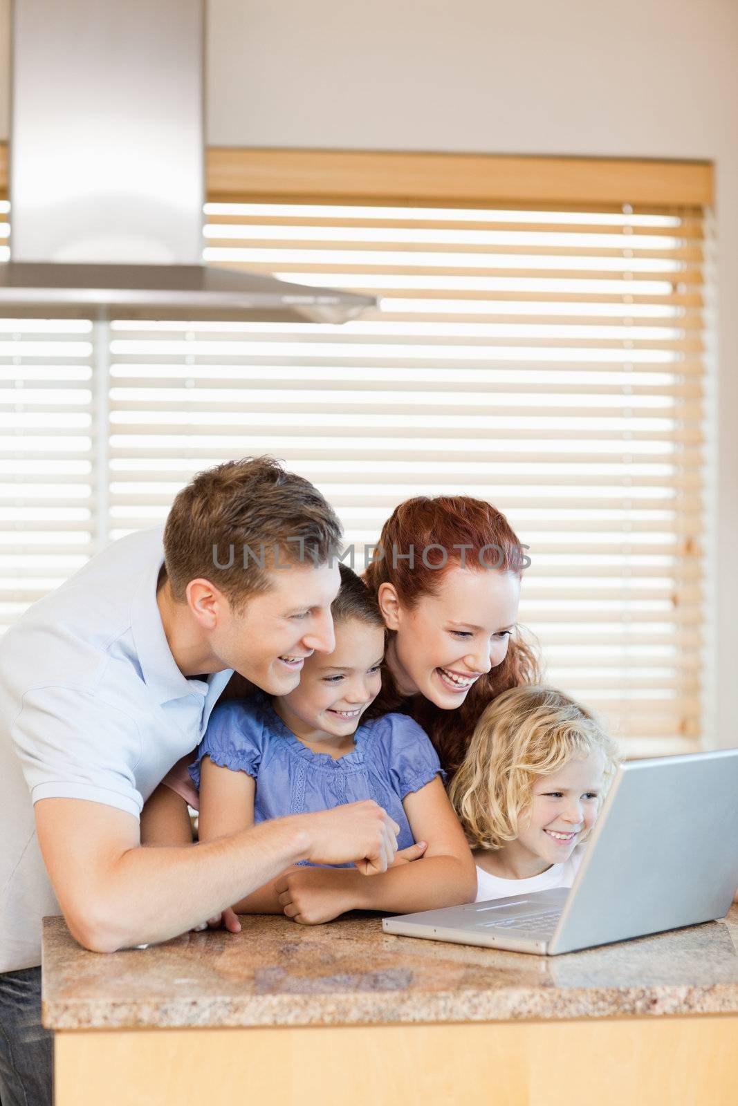 Family exploring the internet in the kitchen by Wavebreakmedia