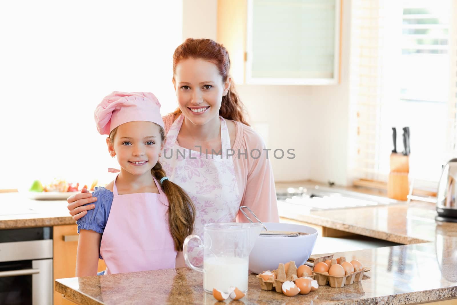 Mother and daughter preparing dough together