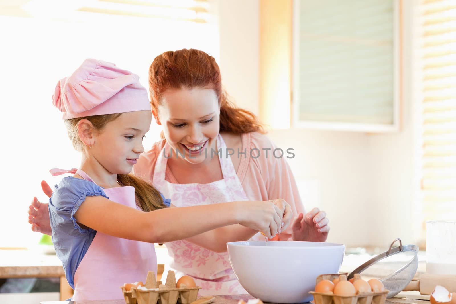 Mother and daughter preparing cookies together