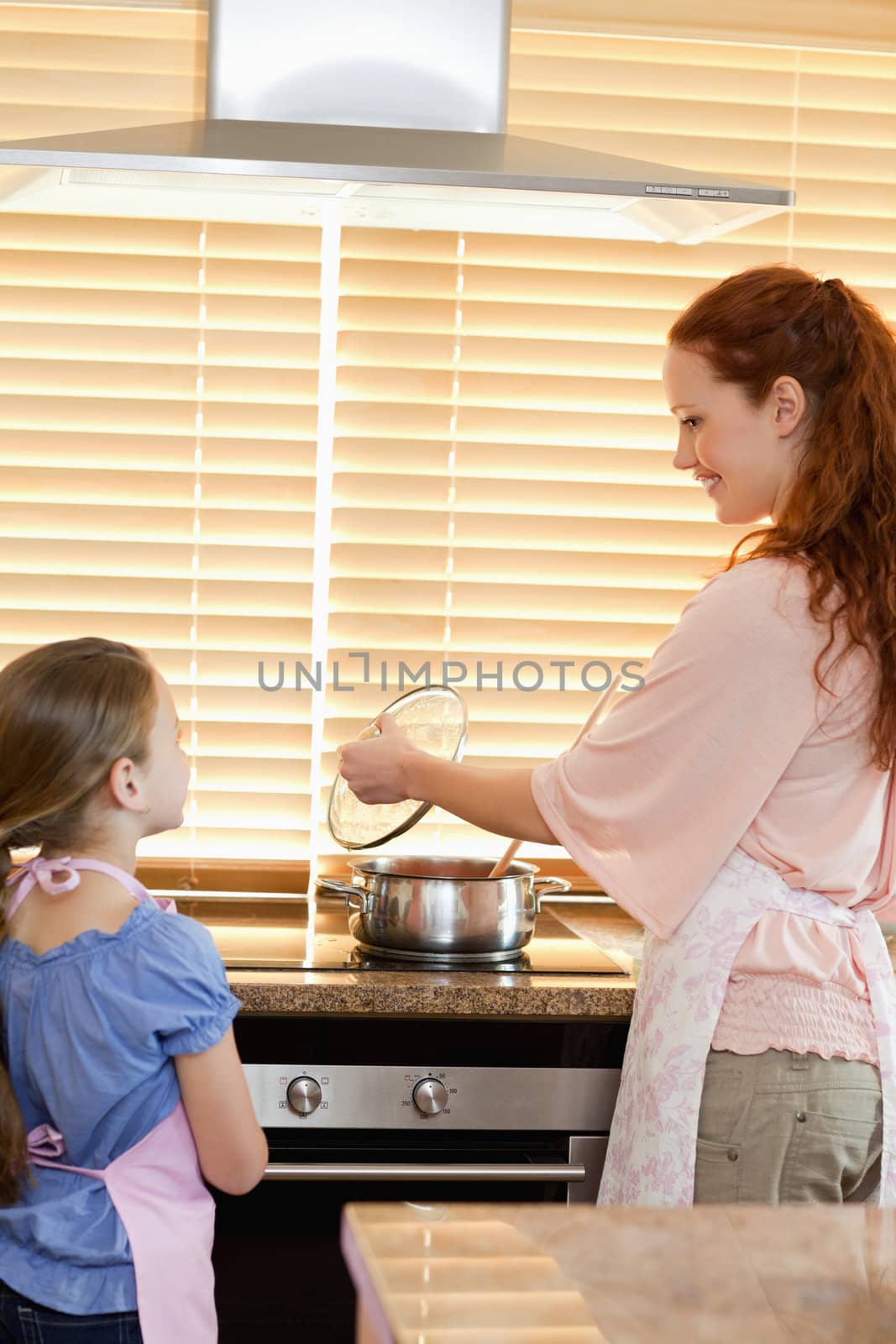 Mother and daughter preparing meal together