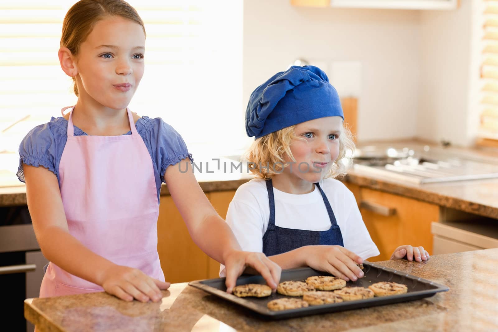 Happy siblings enjoying cookies together